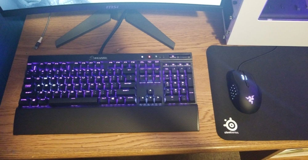 Peripherals, the Corsair K70 Rapid Fire and the Razer Naga Chroma, also set to purple and white.