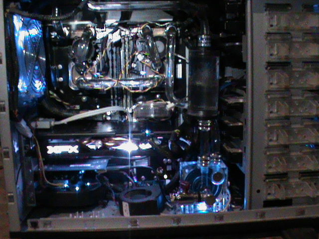 Here you can see the primary components of the system, CPU blocks, VRM blocks, pump, secondary reservoir, the dual Southbridge chipset air cooler and complete custom Motherboard Armor.