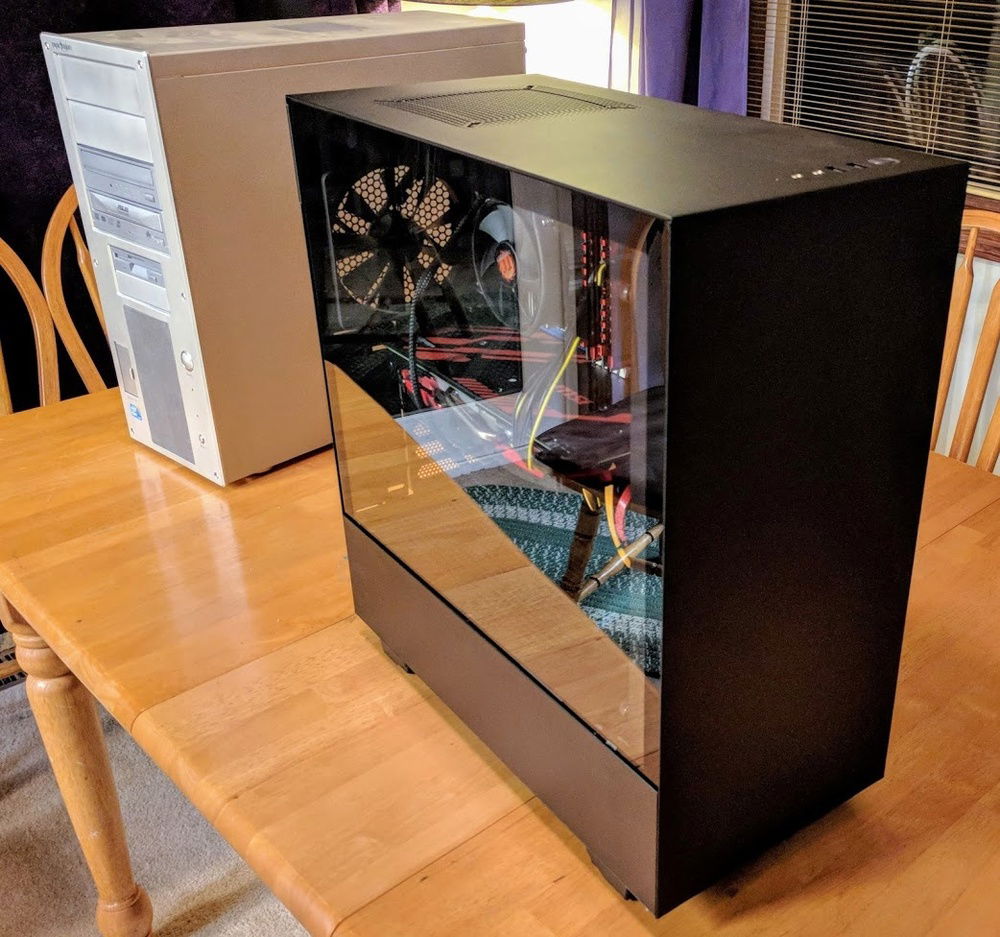 New case with glass side panel, old case behind it (Coolermaster Praetorian)