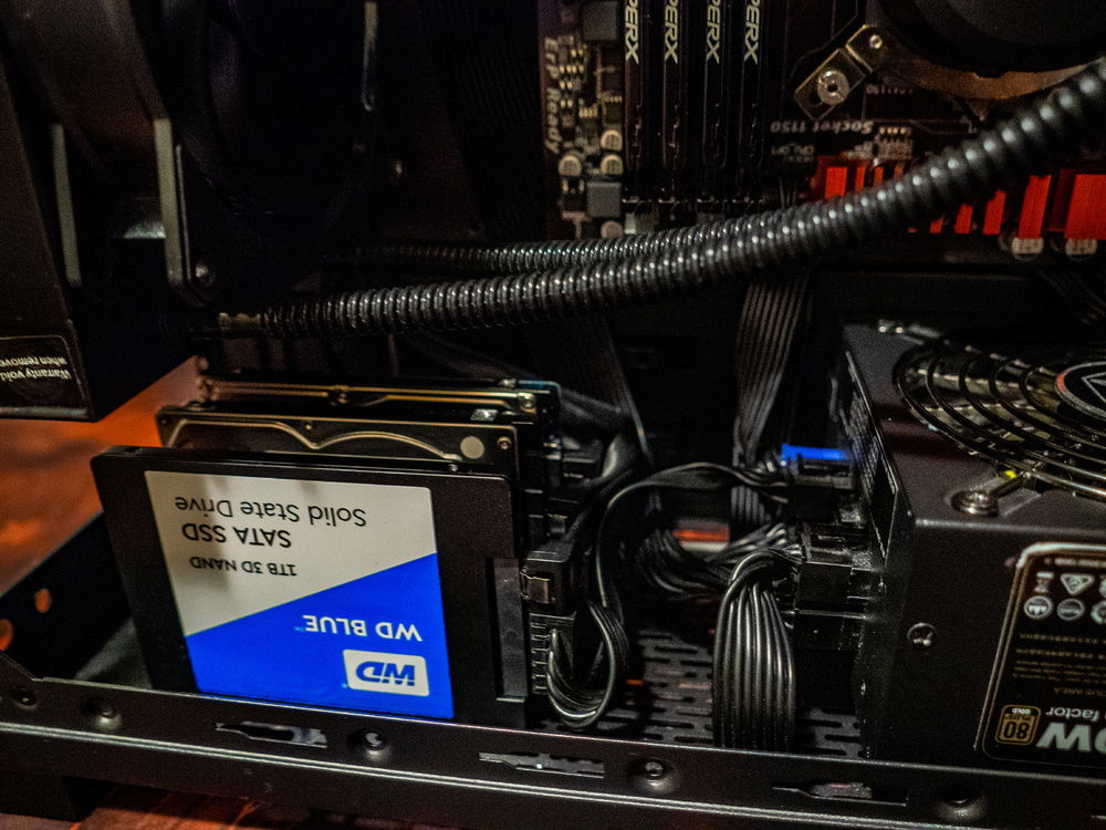 Took out the hard drive cage and improvised a vertical mounting style for the hard drives