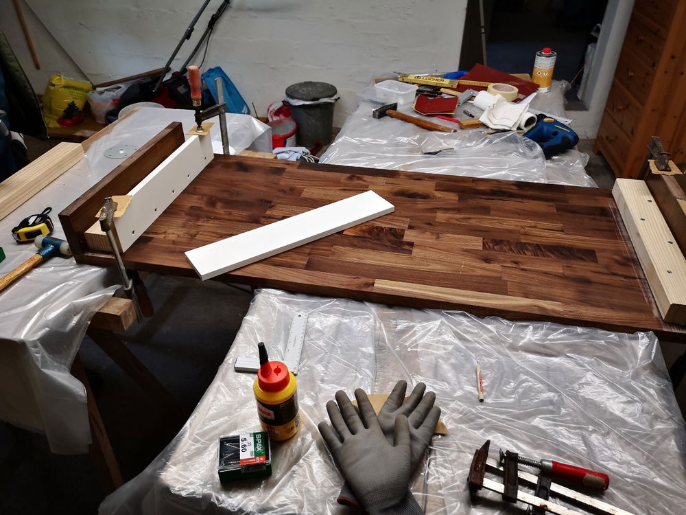 the desk is made of walnut wood, oak planks and oak strips