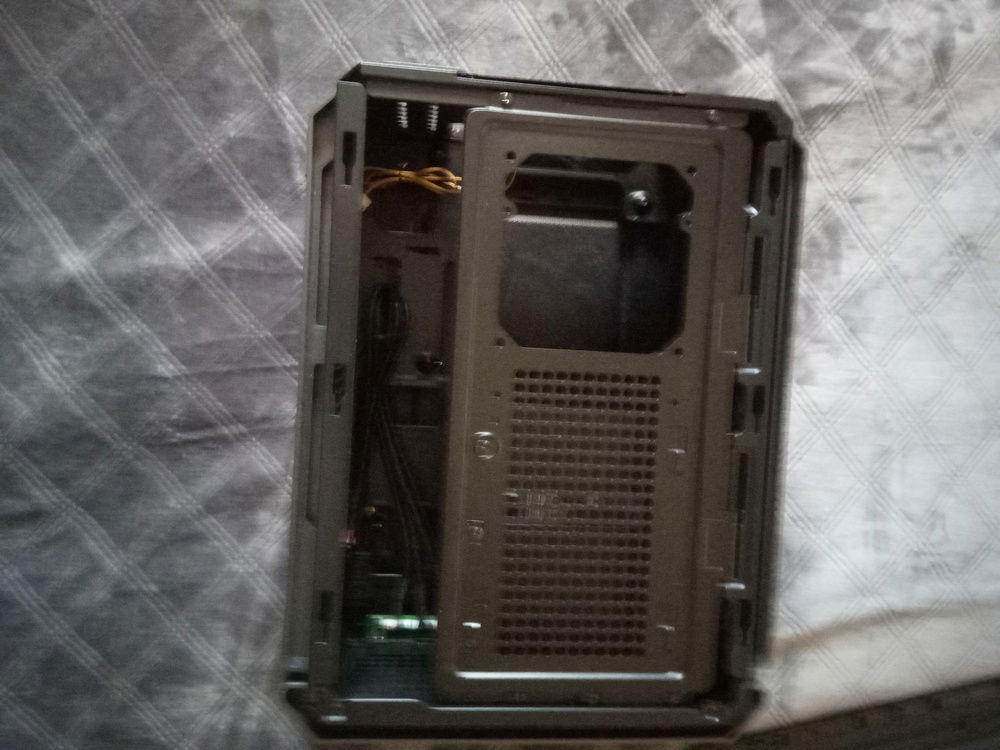 case same side view, cover off. That panel is on a tool-less removable hinge. 3 drive cages on the underside of the hinge panel.