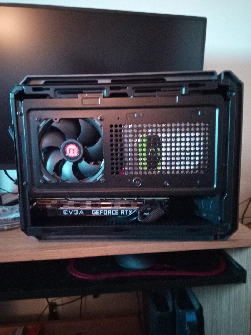 With everything together and hinge panel down and secured. Can't see the chaos underneath. ThemoTake fan as an intake, mainly to move cool air to the rest of the interior besides the CPU. There's one on the top of the case as well as exhaust.