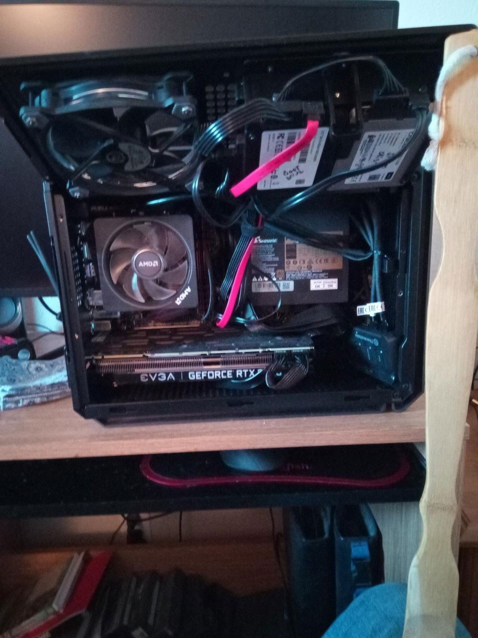 Under the hinge panel, fan controller and drive cables. The red SATA cable is for the boot drive, makes it easy to identify. Doesn't get seen unless everything is opened.