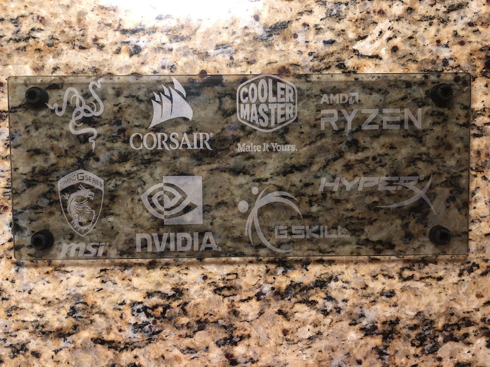 Custom engraving on the top tempered glass panel (done by the wife and I) that represents most of the major brands associated with the build.