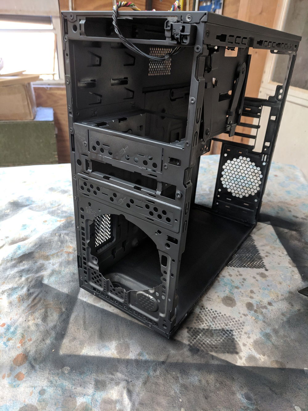 After cutting hole into case for a 120mm Intake Fan and painted interior black.