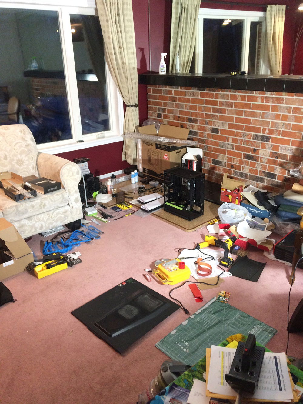 The disaster zone of a work space. Terrible decision to work on the floor.
