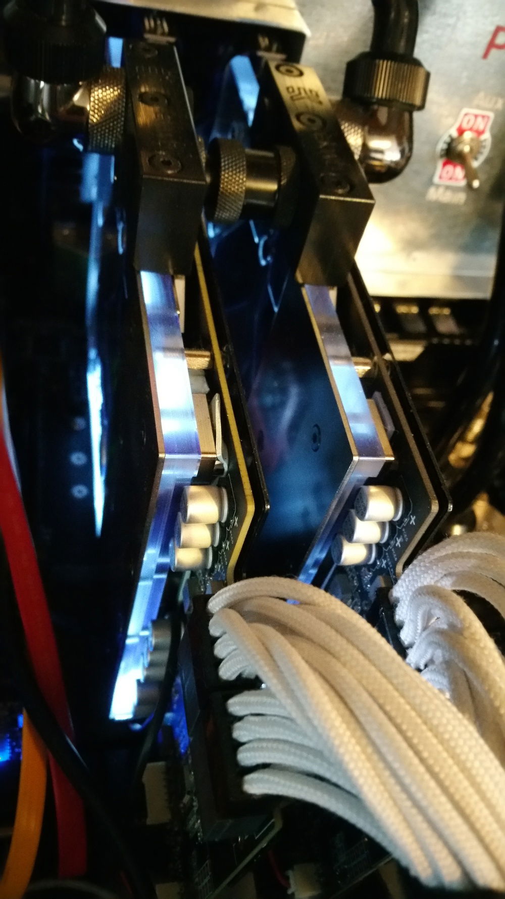 The dual 980ti Strix cards with EK waterblocks. I moved the LED from the stock cooler to the bottom of the waterblocks to keep the controllable lighting effects intact.