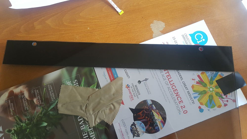 Cut and stuck on black vinyl to the tempered glass to hide the LED strip (up top)