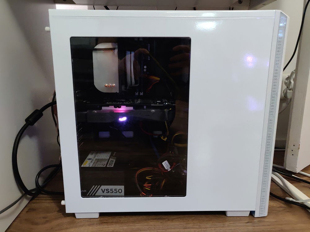 The PC on with pink STRIX logo visible.