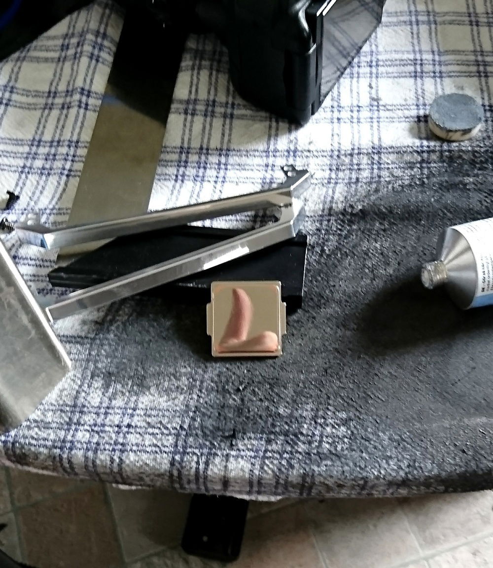 Both sides of the IHS was polished to a mirror image.
Liquid metal, high heat silicone sealant and a clamp to keep them under pressure and it was back to normal but with better temperatures!