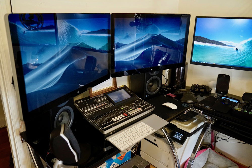Left-side desk.  Contains Mac Pro (2013); 27" Apple Thunderbolt Displays; Roland Video/Audio mixer; AudioEngine A5+ reference speakers.  Under this desk is an Epson Stylus Pro 3880 large-format photo printer.  In the corner is an HP Color LaserJet m475dw (printer/scanner/copier).