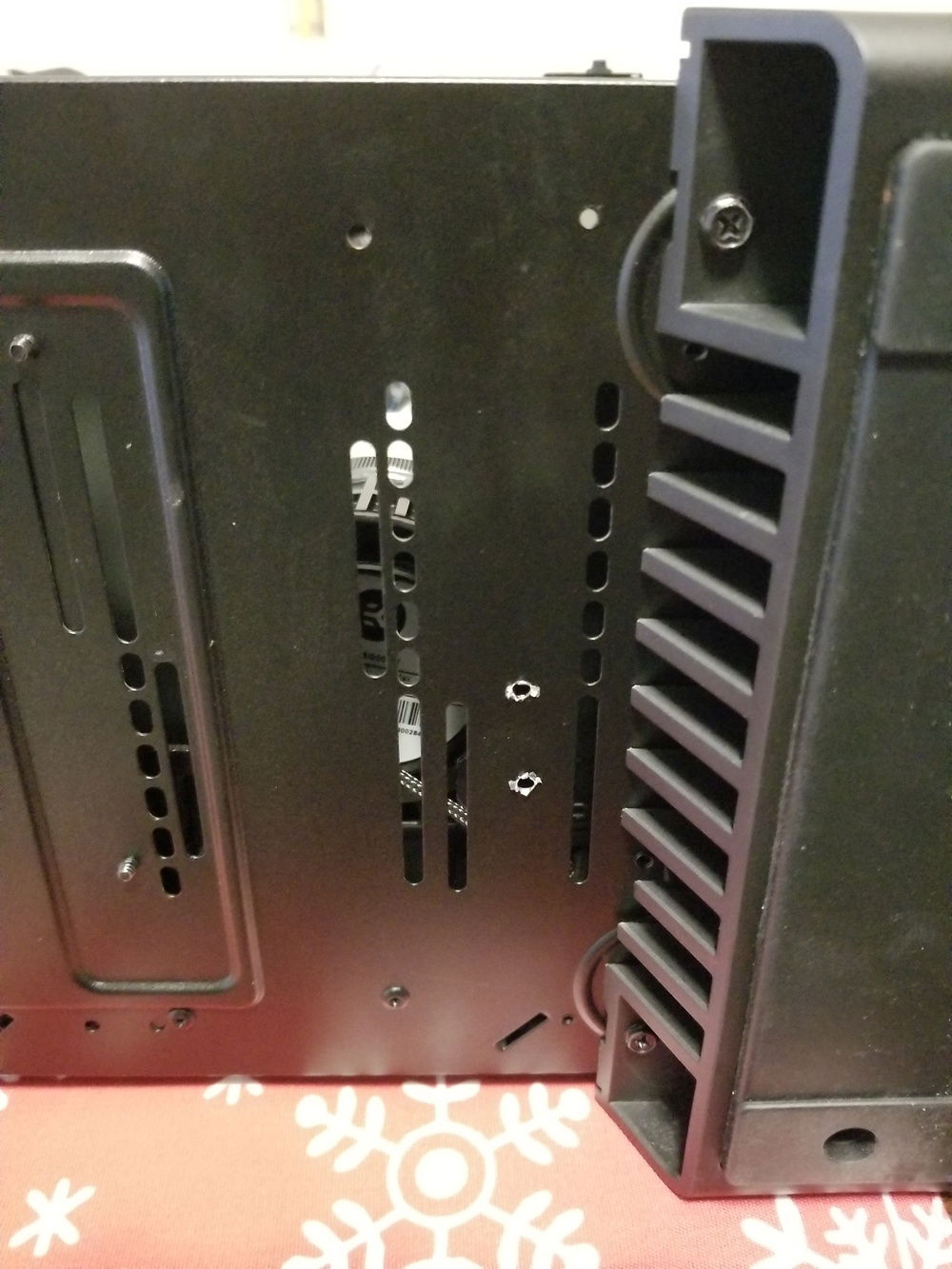 Bottom of case with holes drilled.