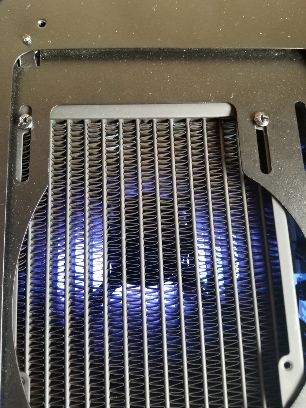 The fan/res mounting slots on the top of the case are offset and made to fit both 120/140mm fans. Since I went with the slightly thicker PE360 rad in the front I had to position the top rad back abit further to give myself enough room to reach the fittings on the front rad. I did this by making use of one of the mounting slots which was slightly longer for 140mm fans and extending the opposite slot enough to get the rad back and straight and then drilled an extra mounting hole where I had enough to do so since nothing else lined up anymore. The rad is very solid both with the hard tubing not installed and with. This is also not able to be seen with the cases dust filter and glass installed.