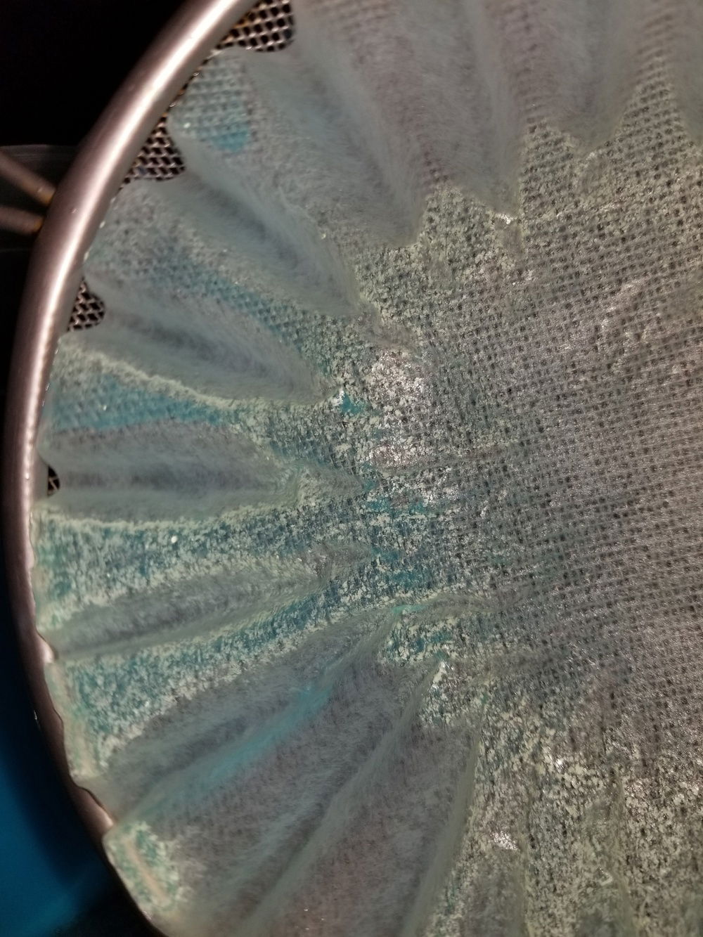 I complexly drained while saving the coolant and flushed the loop multiple times. I then tore it apart once more to clean and flush everything out. Once done I reassembled and rechecked for leaks. Then I used coffee filters to filter the new coolant they sent me before putting it back into the system since I could not wait another week for potentially more bad fluid from them. The filters caught a bunch of this small particulate. I believe it is larger excess UV reactive component they use in their uv reactive solid line. Checking my loop tubing with a flash light and the uv lights on the cpu block shows it still has finer UV particles that did pass through the filter. Days later I do not have the massive build up issues. However I am unsure if filtering this coolant may or may not have effected its anti-corrosion/anti-growth properties.