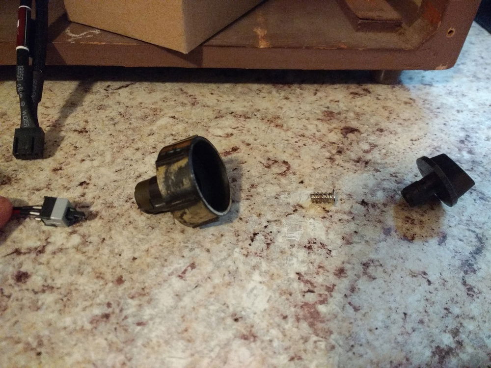 How the power button passes through the radio knob. Lots of hot glue and an extra screw.