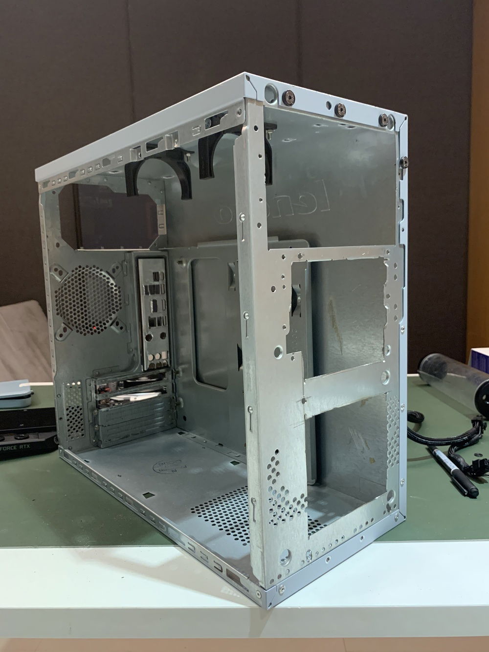 Cutting the aluminum frame airflow and drilling holes for radiator mount.