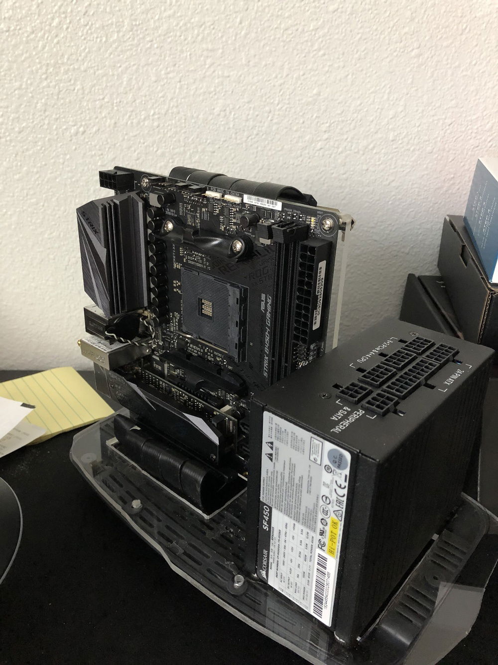 The frame of this build is basically a piece of acrylic with the motherboard on one side and the GPU on the other side. The central piece is attached to another base piece of acrylic which screws in between the stock toaster base and the top "shell" piece.