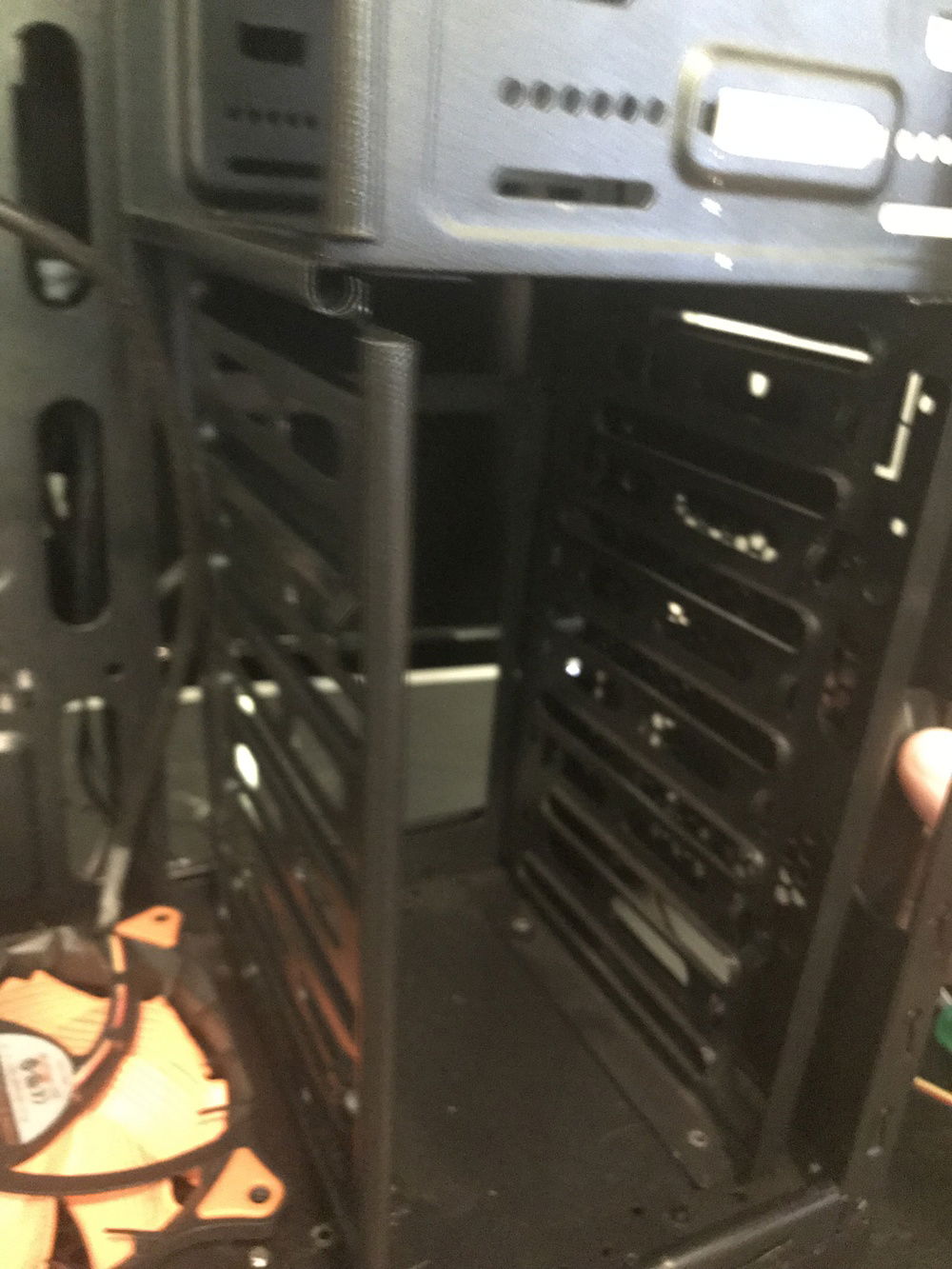 This drive cage blocked the removal of the included case fan. I drilled out (aka used a Dremel) to take out the rivets. Ditched these drive bays.