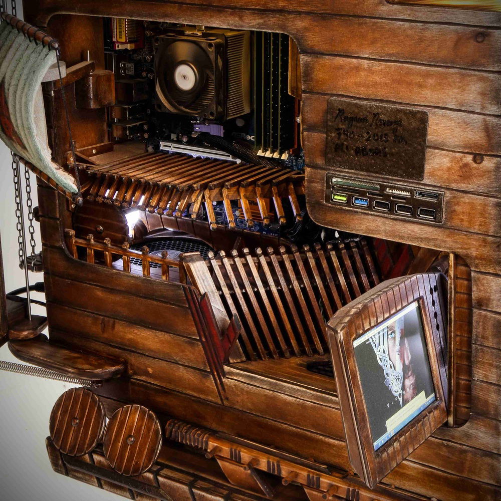 didnt want any ports or anything anywhere tp ruin the theme in th front, so they are revealed when he doors open. th monitor is servo driven and is out in this picture. the psu is clad  in wood too and i call it odins temple :-)