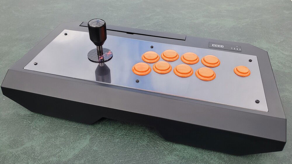 One of my favourite arcade sticks, a custom Hori RAPV. Custom face plate, Seimitsu Nobi Pro joystick, and orange silent Sanwa buttons.