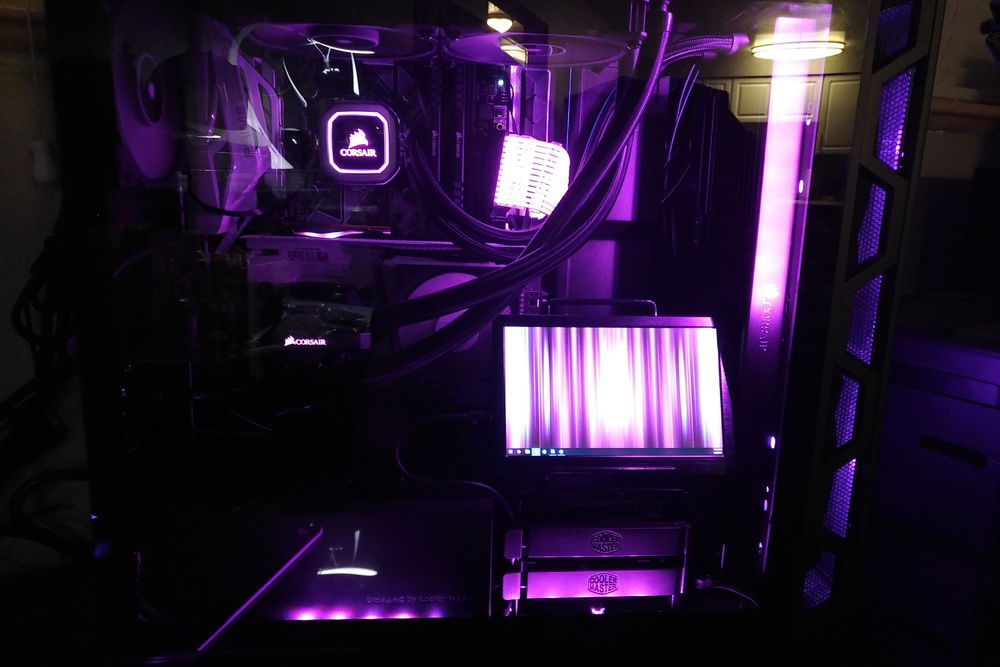 Internal monitor on a stand sitting on the hard drive caddy