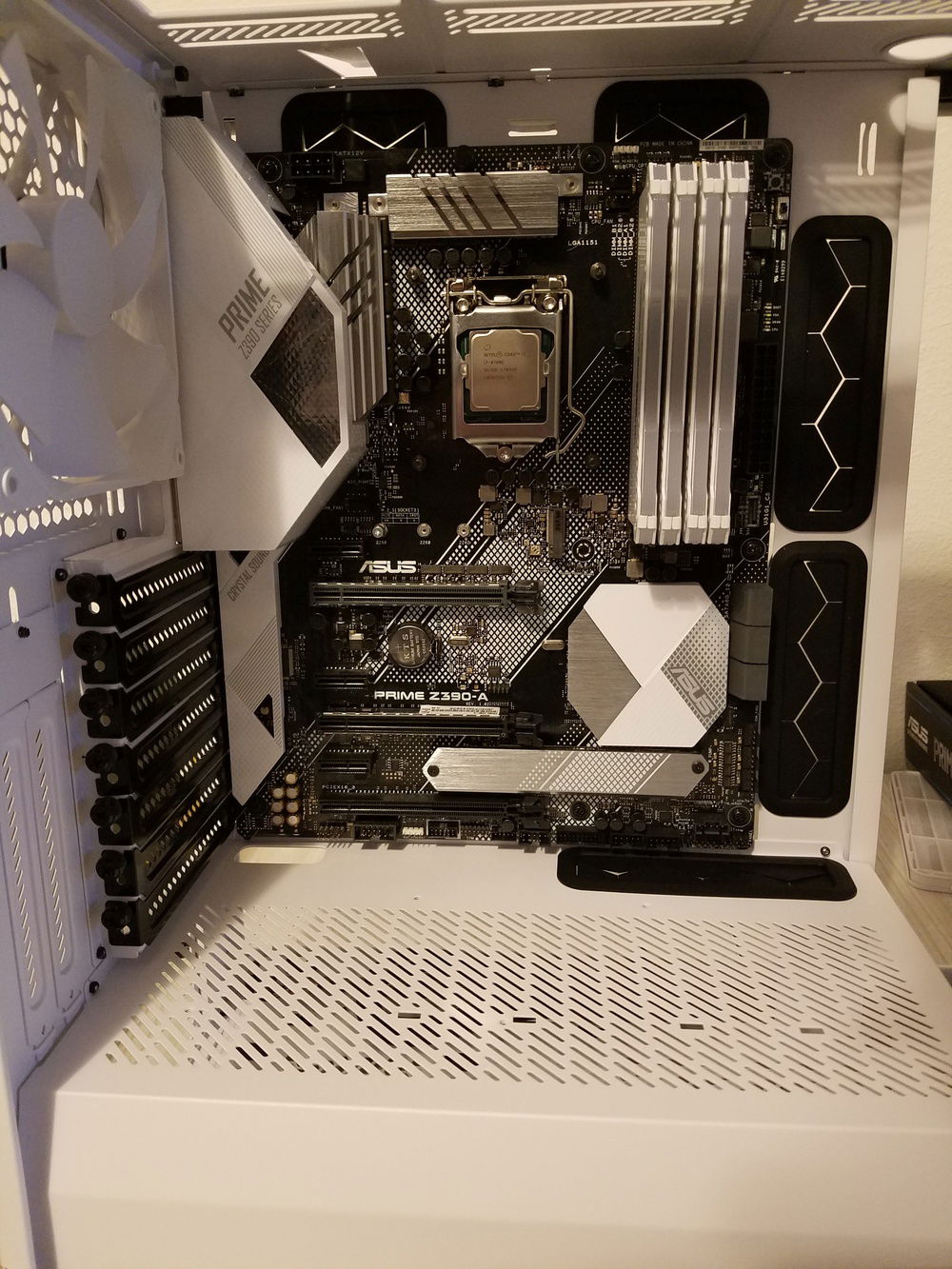 Cpu installed into the Asus Prime Z390-A mobo, backplate for the Corsair H100i Platnum installed, there are x2 M.2 slots on this mobo I installed the Samsung 970 PRO in the lower M.2 with the heat shield for afew reasons. 1 The other m.2 is directly above the slot for the GPU, and 2 it has no heat shield. x2 Corsair Vengeance Pro 16gb DDR4 ram @ 3000MhZ. I picked up two blank sticks of the Vengeance Pro to give it a cleaner look, and my OCD couldn't handle the gap. LUL