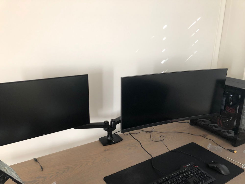 New amazon basics dual monitor arm. Would highly recommend!