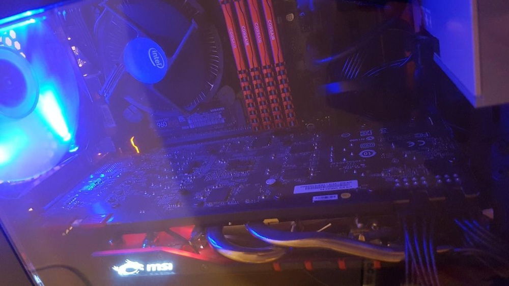 Close up of that juicy red ram and video card with the lovely blue lights overseeing it all.