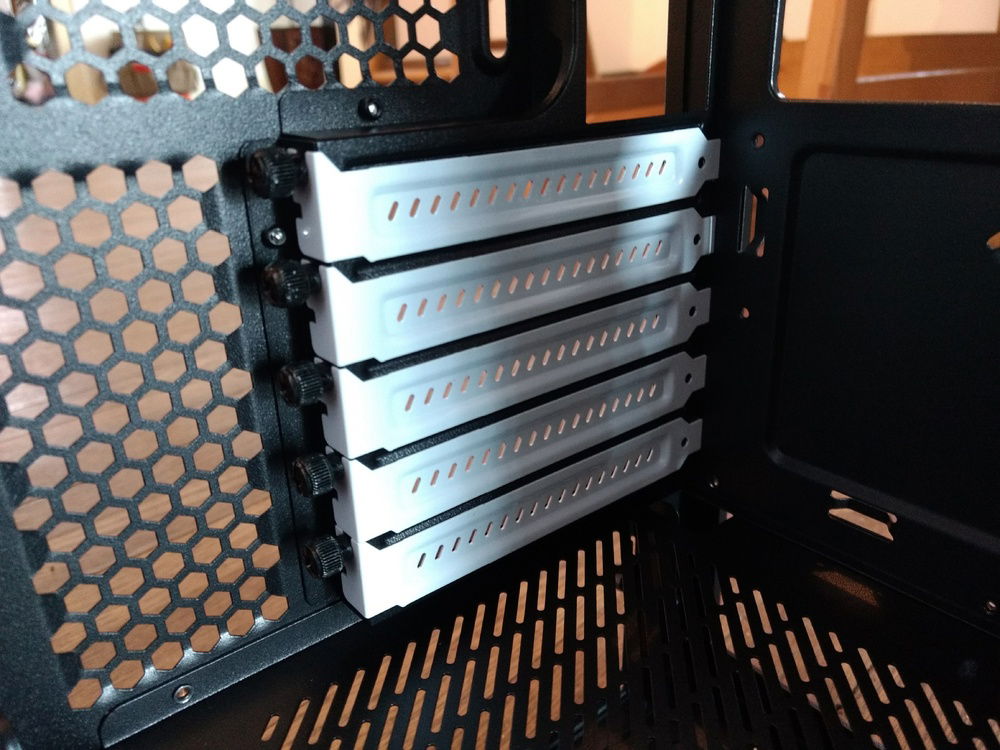 You can see they started with White PCIe slot covers. Those quickly got painted Black.