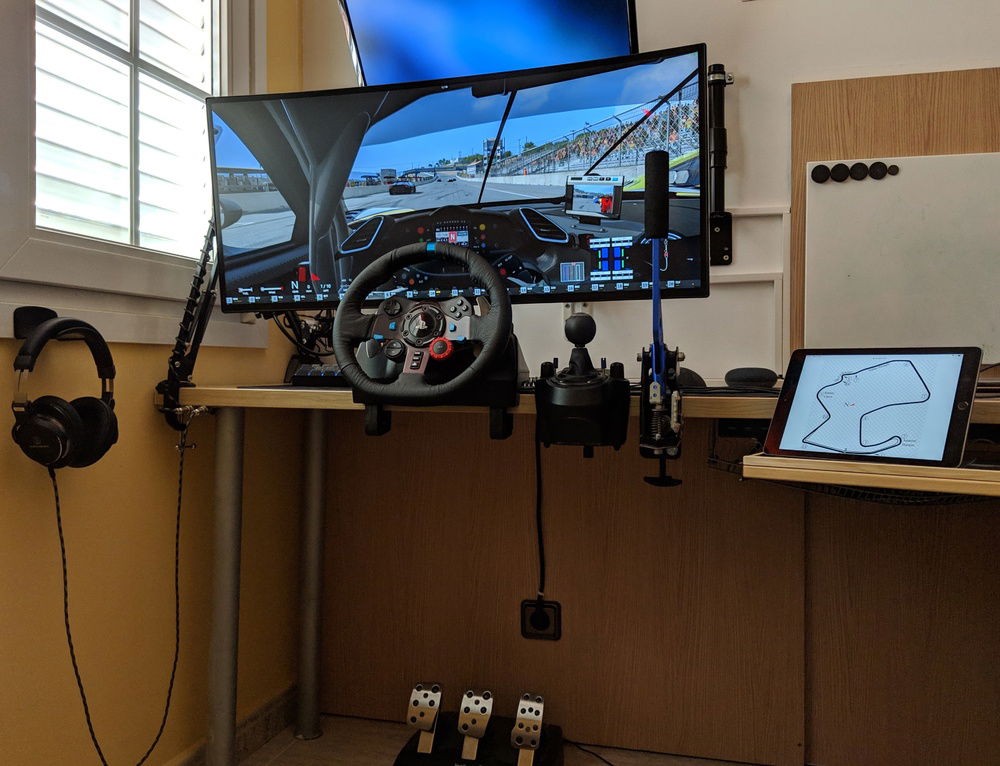 Simracing with custom DIY handbrake and monitor arm extended.