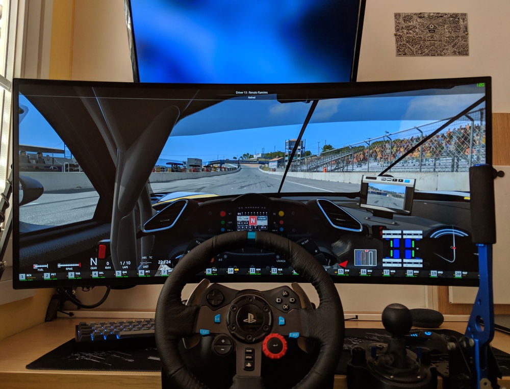 Simracing with custom DIY handbrake and monitor arm extended.