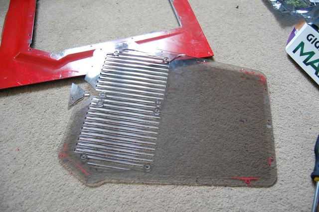 The factory side panel window was broken and had paint on it.  Decided to replace this with a tinted acrylic panel,