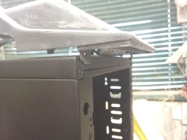 Cutting some metal away to allow clearance for the fan controller.