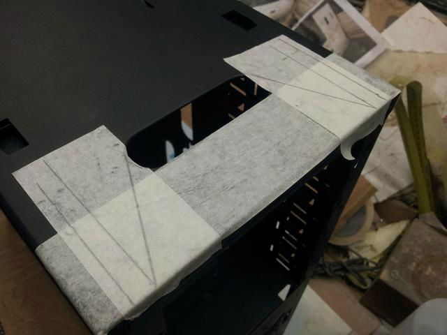 Cutting some metal away to allow clearance for the fan controller.