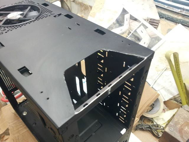 Cutting some metal away to allow clearance for the fan controller.