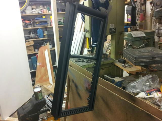 Removing even more factory fan grille material.