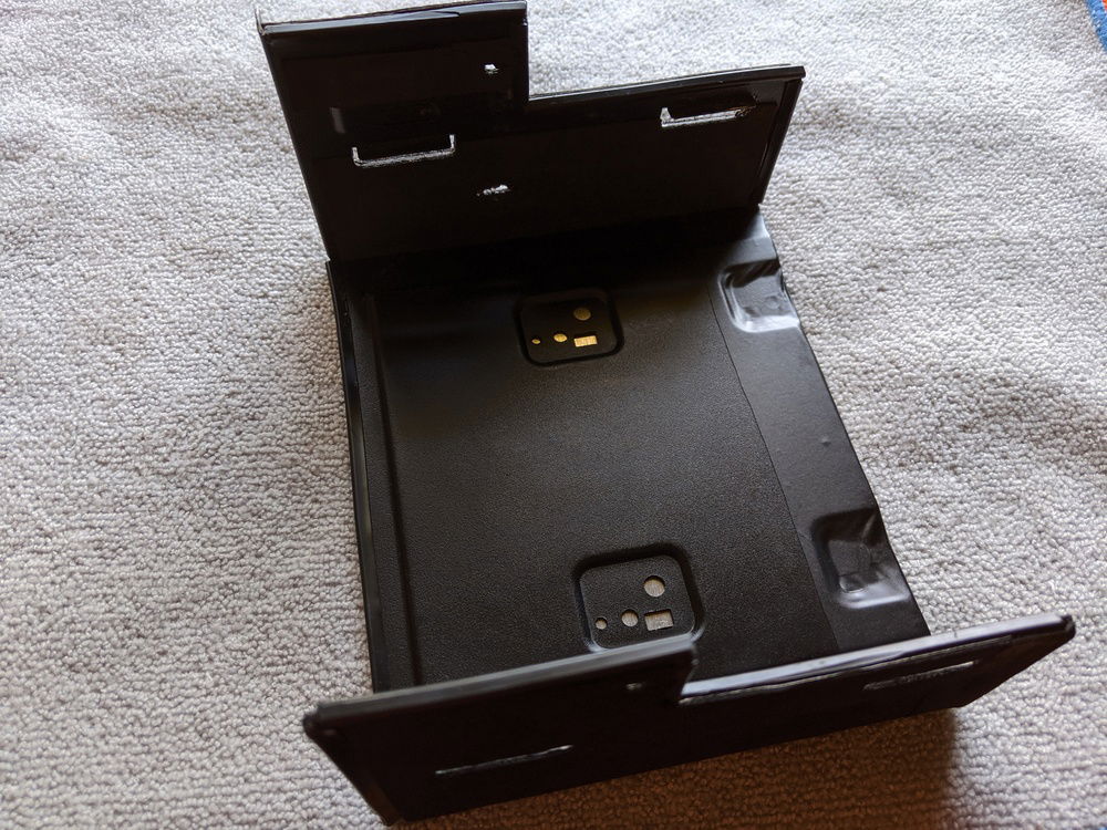 I used the 5.25" bay from my old Fractal Design Define R4 to house my pump/res unit. I cut it to size, attached an aluminum plate to the bottom, wrapped that in vinyl, and then used 3M adhesive padding on the sides.