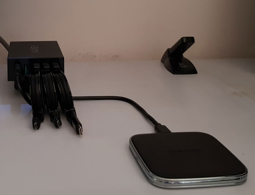 Aukey powered USB hub, provides 4 ports 2.4 amps each and one port with Quickcharge 2.0 Awesome charge station, when paired with rollable cables and a wireless charging pad.