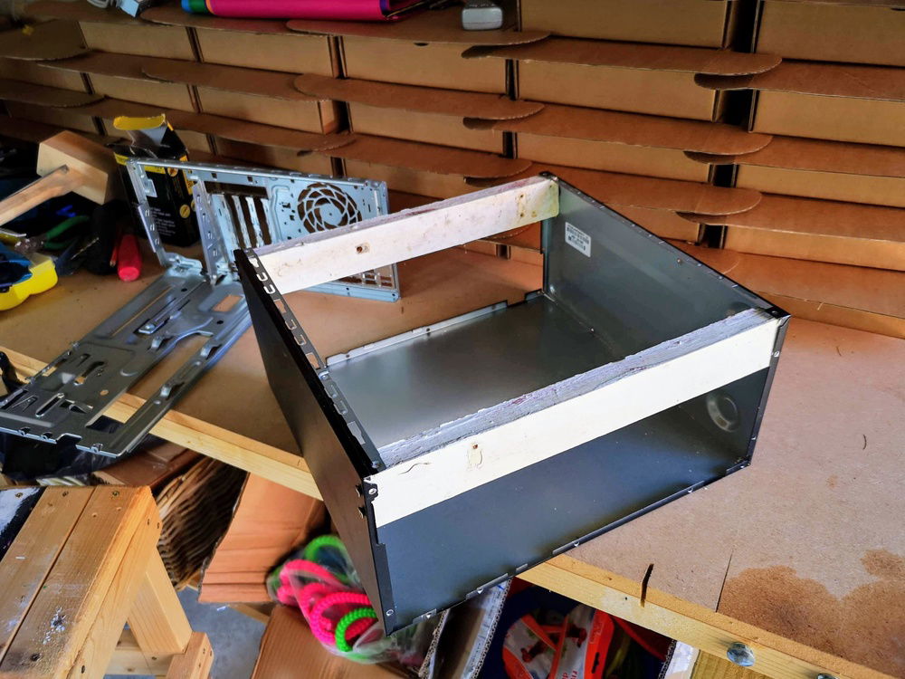 I took out the motherboard tray and I/o shield area. I added to wooden beams to create the base.