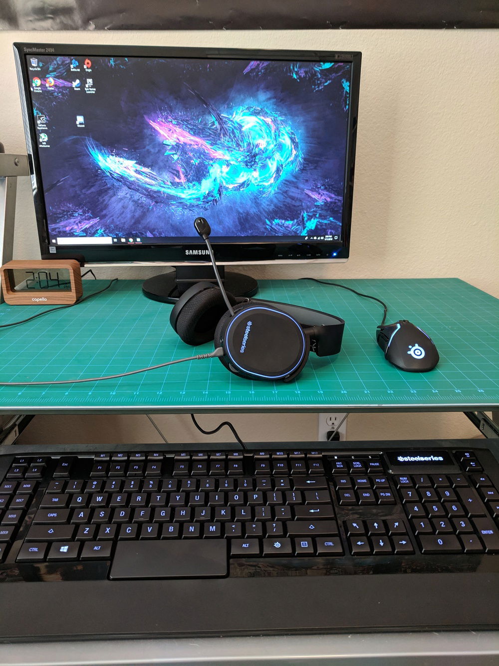 Keyboard tray is actually gone now and the keyboard liveas on top of the desk. The desk is a glass surface covered by a self healing cutting mat that I use when making vinyl decals (my other hobby). When I discovered that it makes an excellent mouse pad, it earned a permanent home on the desk. Lucky enough the one I bought just so happened to be the same size as my desk.