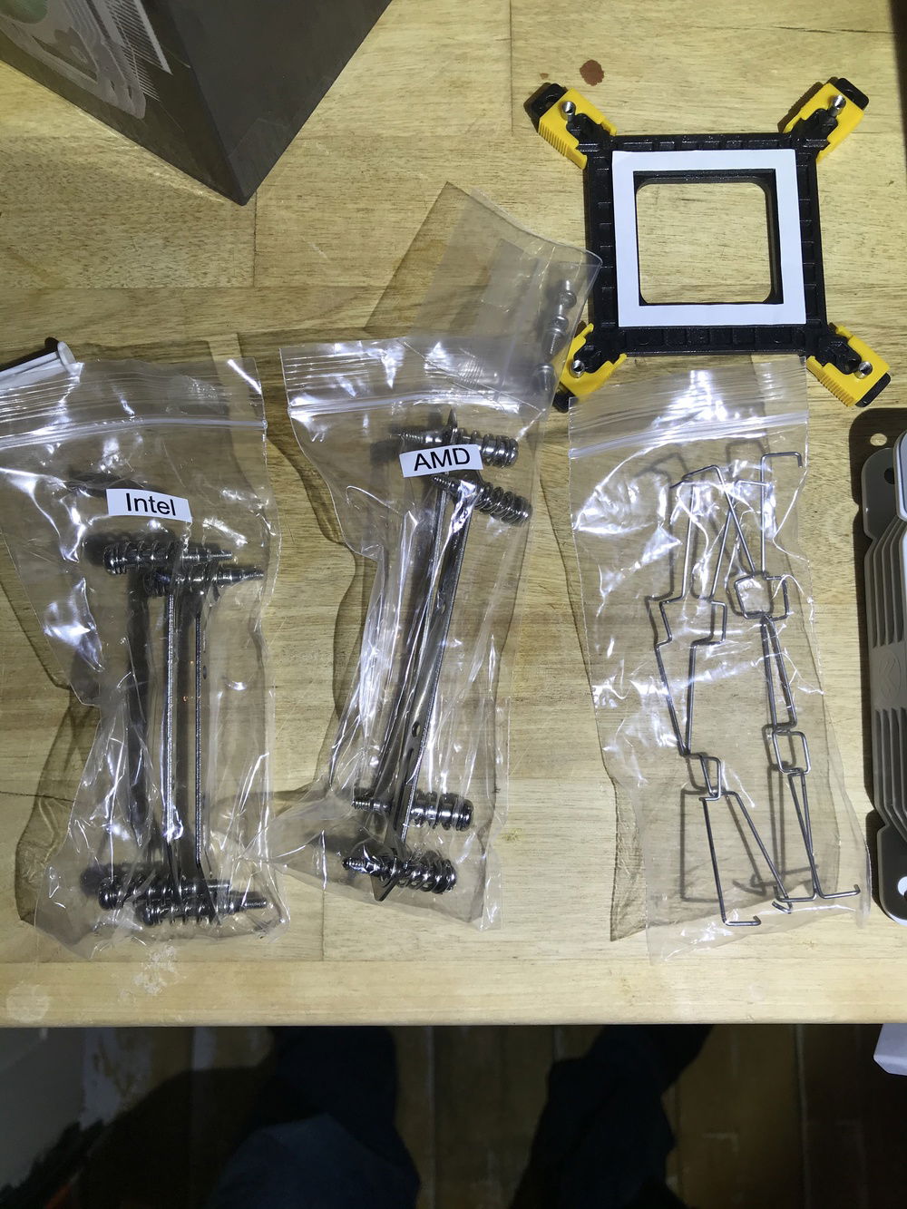 Inside the Big Bang you get:
Intel back plate
Intel bracket 
Amd bracket
4 fan retention clips 
4 bracket screws very clearly marked up