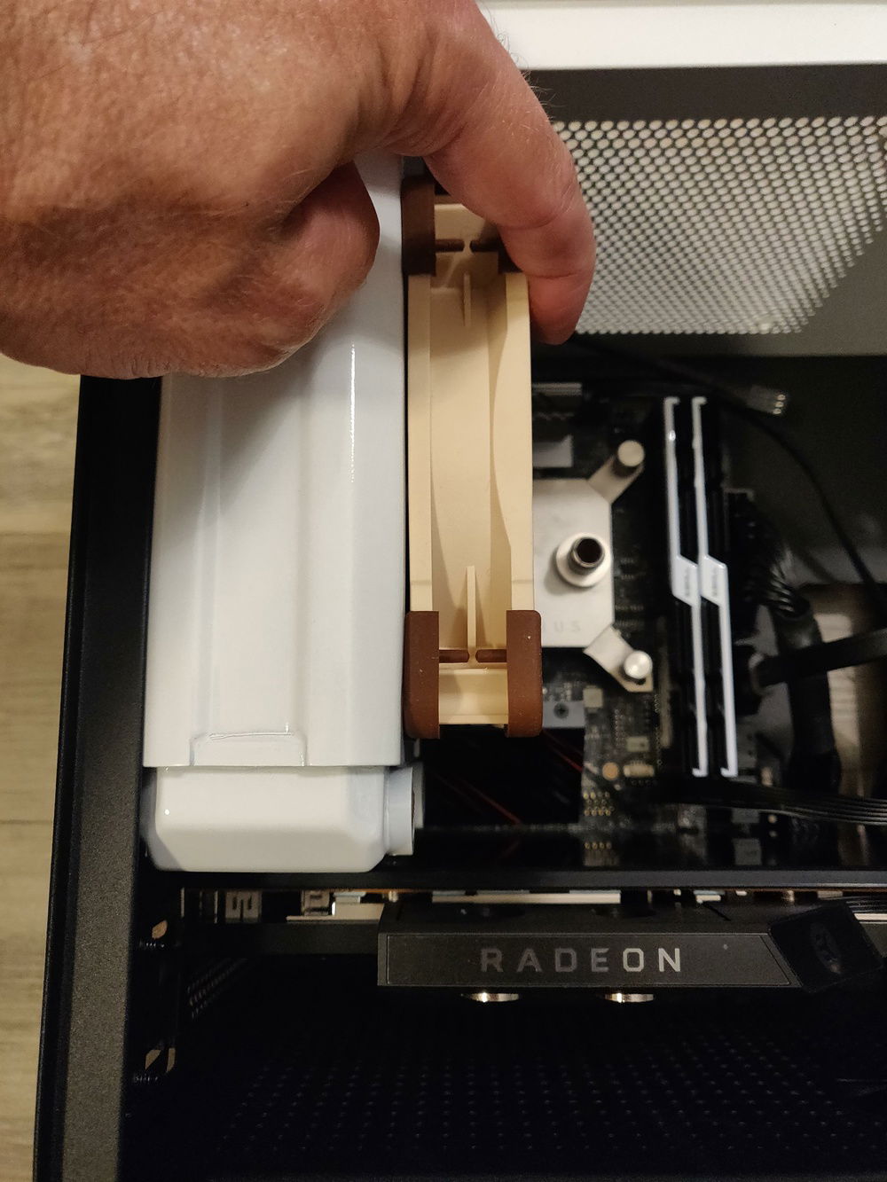 Here I show that the depth of the radiator is too much. With the fan attached it'd overlap one of the CPU water blocks' ports.