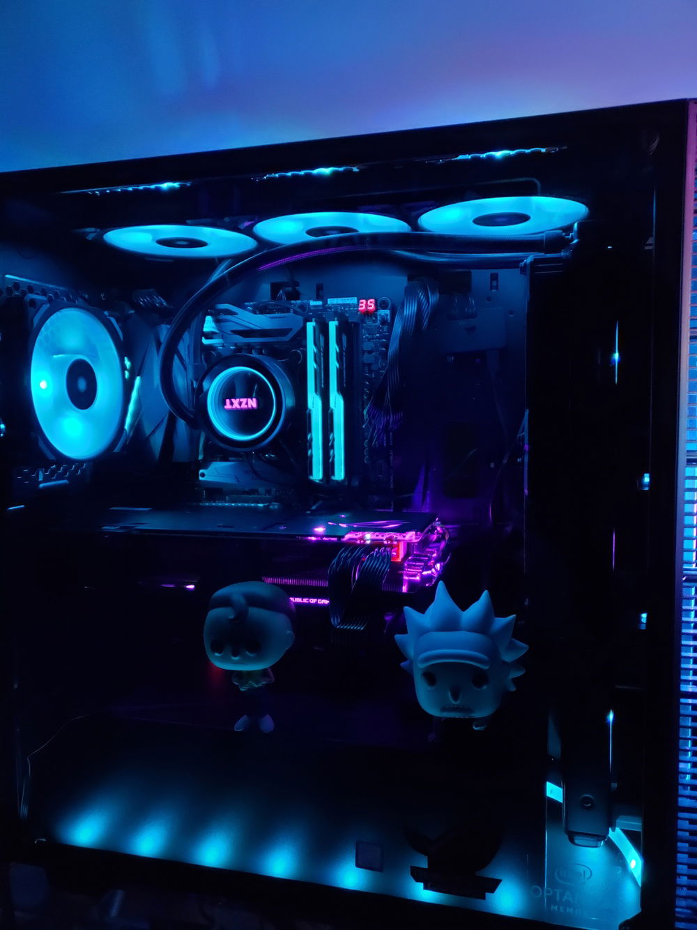 Side view with the tinted glass panel back on. Colors phase between this blue and the purple in the next picture. Morty barely fits in there due to the large hunk of GPU I have sitting in the case.
