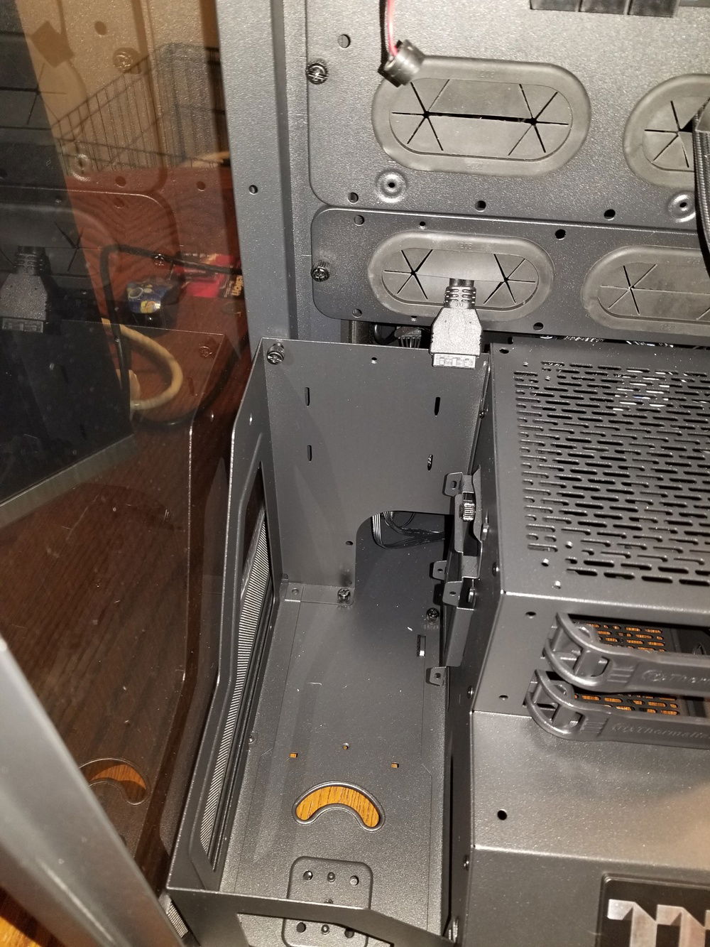 There is a styled metal trim on either side of the hard drive cage.  I wouldn't say it's flimsy by any means, but it does have some flex when pressure is applied.  I worry about the weight of such tall reservoirs when they're filled with coolant twisting them.