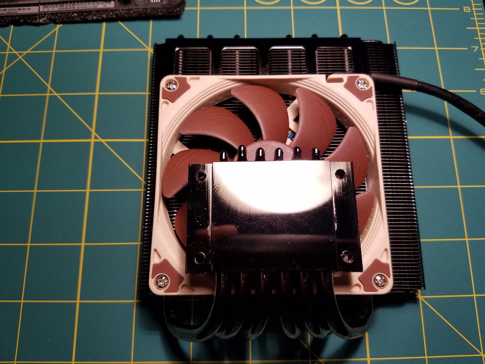 The stock fan on the Black Ridge cooler was too loud. I swapped it out with the slim Noctua 92mm fan. The push orientation of the fan (as shown) was less efficient and louder than a pull configuration.