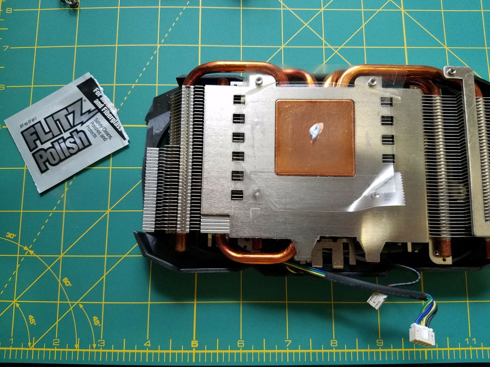 Buffing the stock heat sink to prep for liquid metal application.
