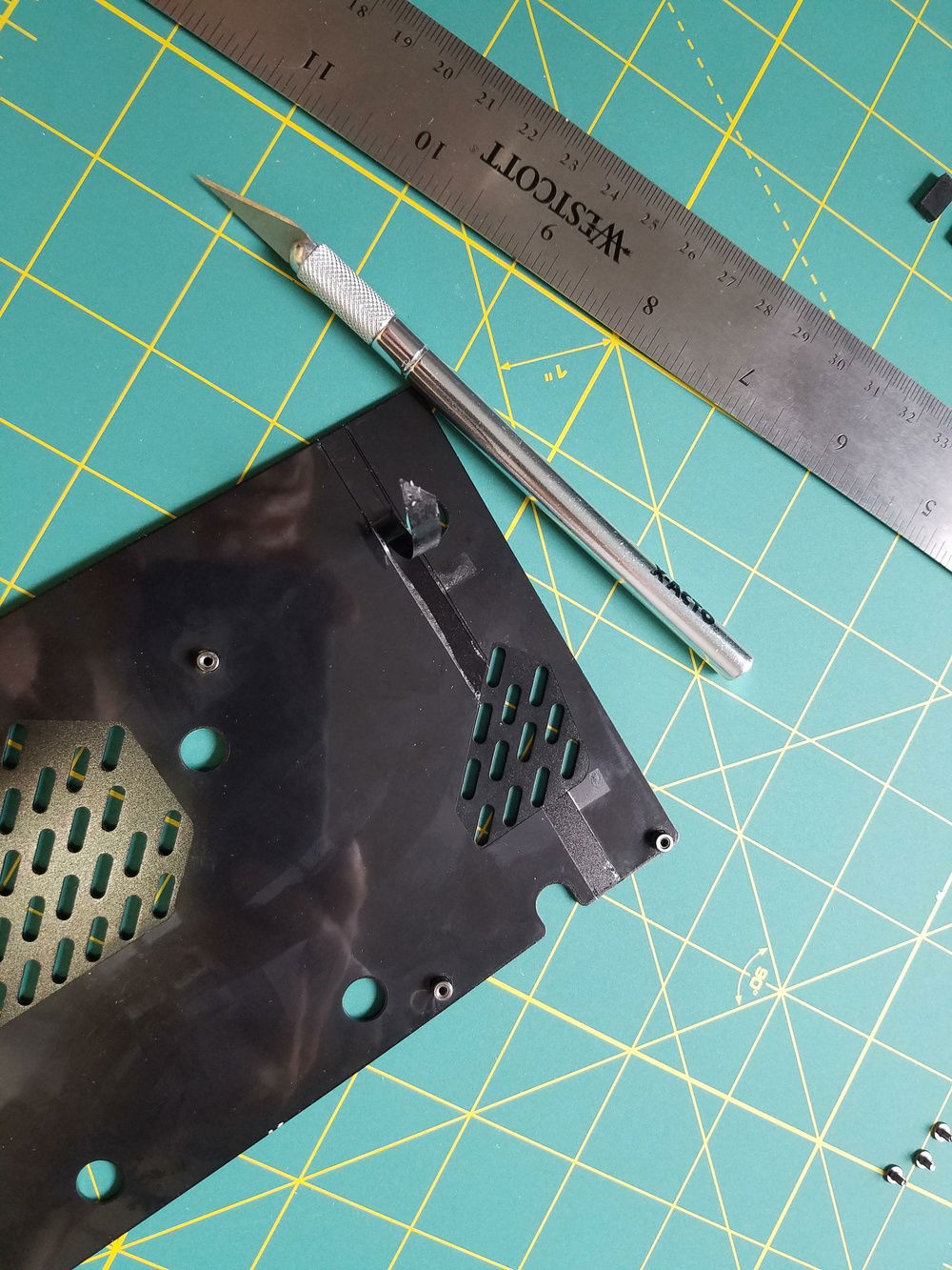 The GPU back plate has a thin plastic membrane that prevents metal contact with components on the PCB. I removed a few small sections over the GPU core and the VRM so that thermal pads would transfer some heat to the back plate.