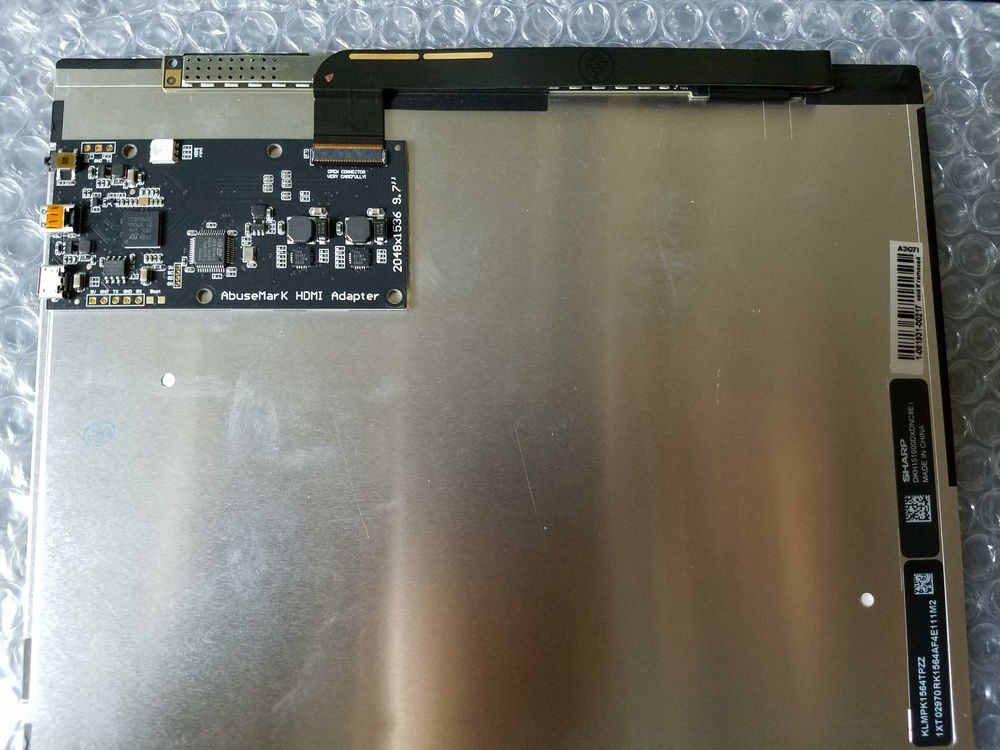 Abusemark iPad to DP adapter installed to rear of iPad 3 display using 3M double sided tape.