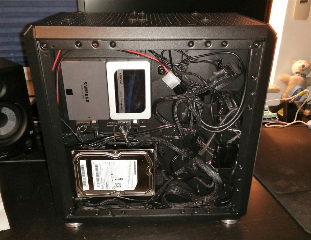 another look at the back with it's cable mess. i wonder if some extension cables, especially for vga and main mobo power connector would make it either more organized or impossible to close the backpanel. remember im working with a non modular PSU here, so i cannot remove any of the cables or use shorter ones